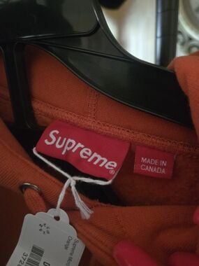Supreme Orange Pullover with Red Brand Tag